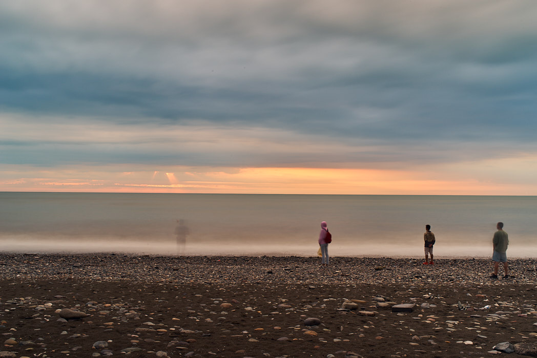 abstract photo of people standing near the sea