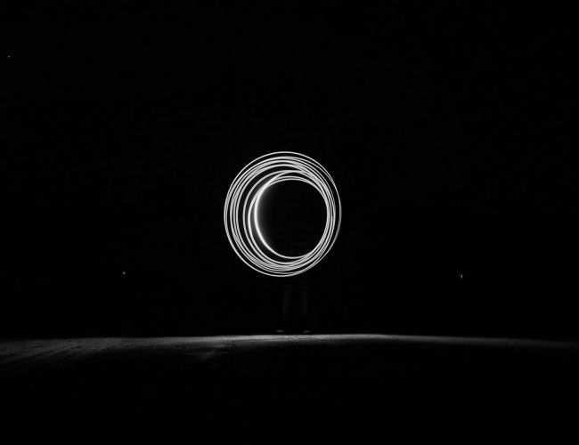 black and white photo of light painting at nigh