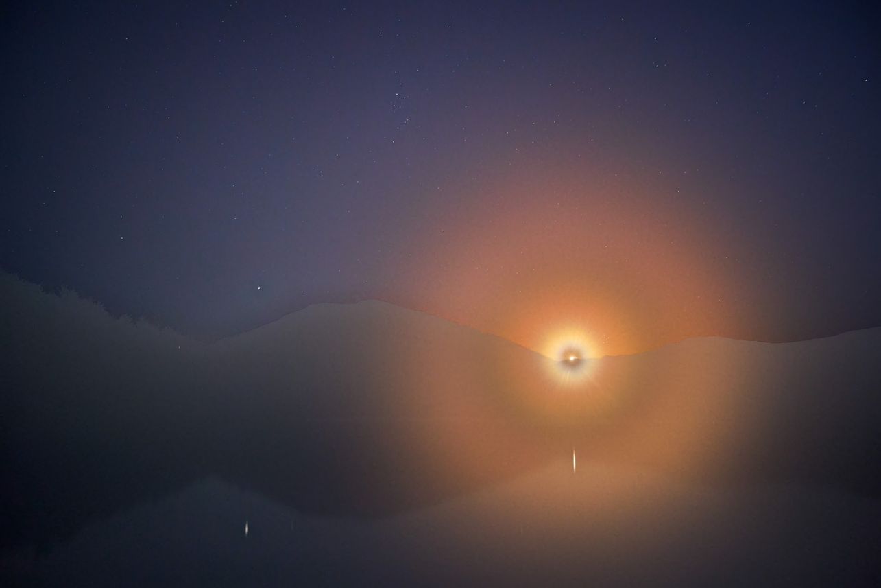 moon rising over mountain lake