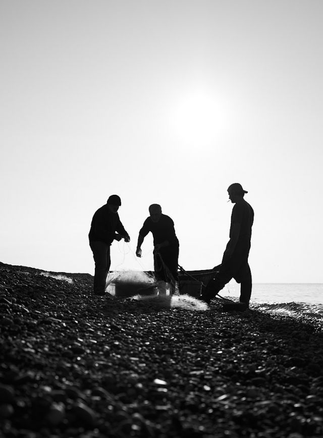 Fishermen at the seashore in black and white