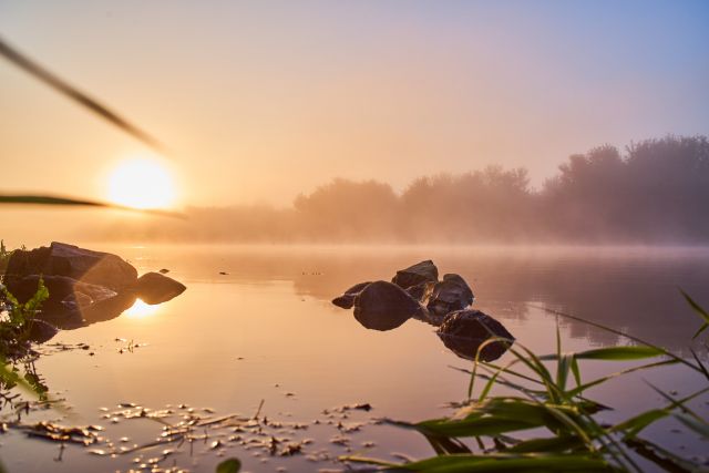 sunrise at the autumn river close to the water