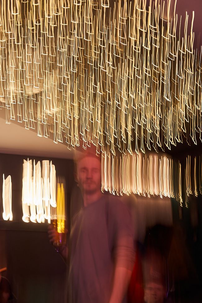 a guy with bokeh background at the bar