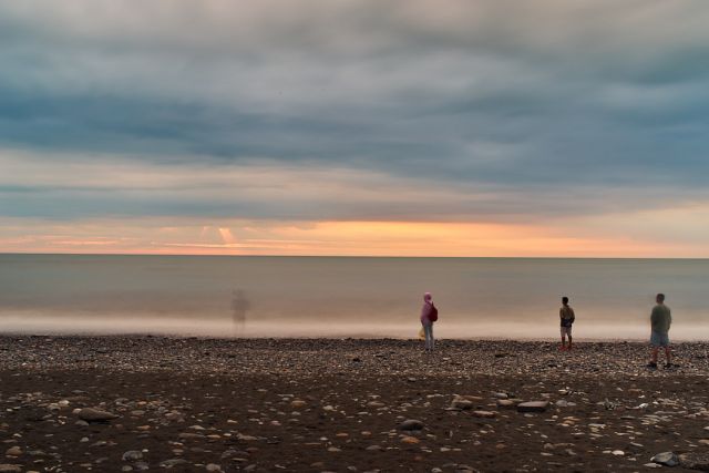 abstract photo of people standing near the sea